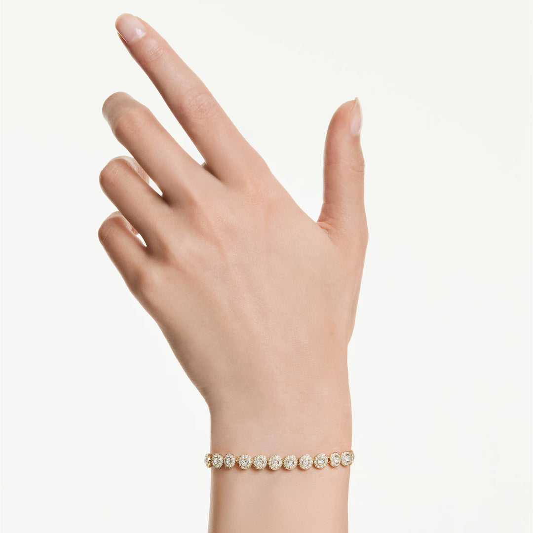 Niche Jewellery Swarovski Una Angelic bracelet with round-cut clear crystals and 18K gold-tone plating on a wrist.