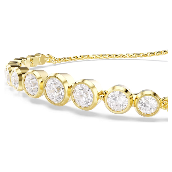 Niche Jewellery Swarovski Imber tennis bracelet featuring round-cut white crystals in gold-tone bezel settings.