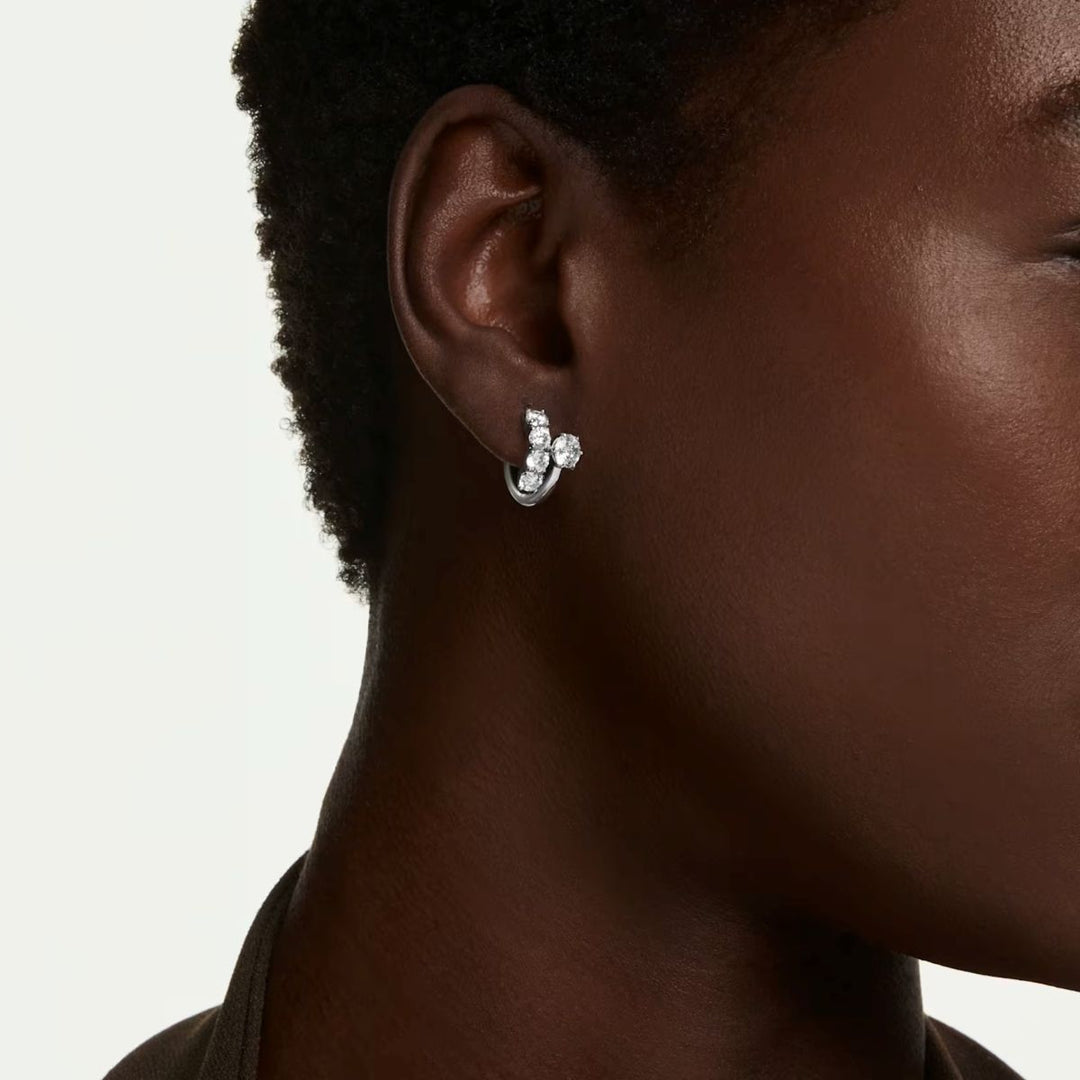 Niche Jewellery Swarovski Matrix hoop earrings with round-cut white crystals on rhodium-plated metal worn on ear