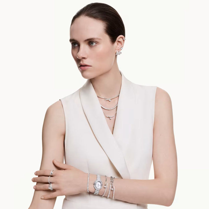 Niche Jewellery Swarovski Matrix hoop earrings with round-cut white crystals on rhodium-plated metal worn by a model