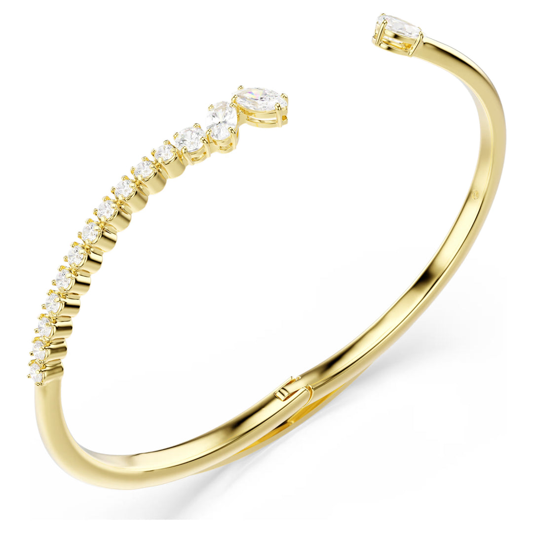 Niche Jewellery Swarovski Mesmera bangle featuring mixed-cut white zirconia stones on an 18k gold-plated open cuff