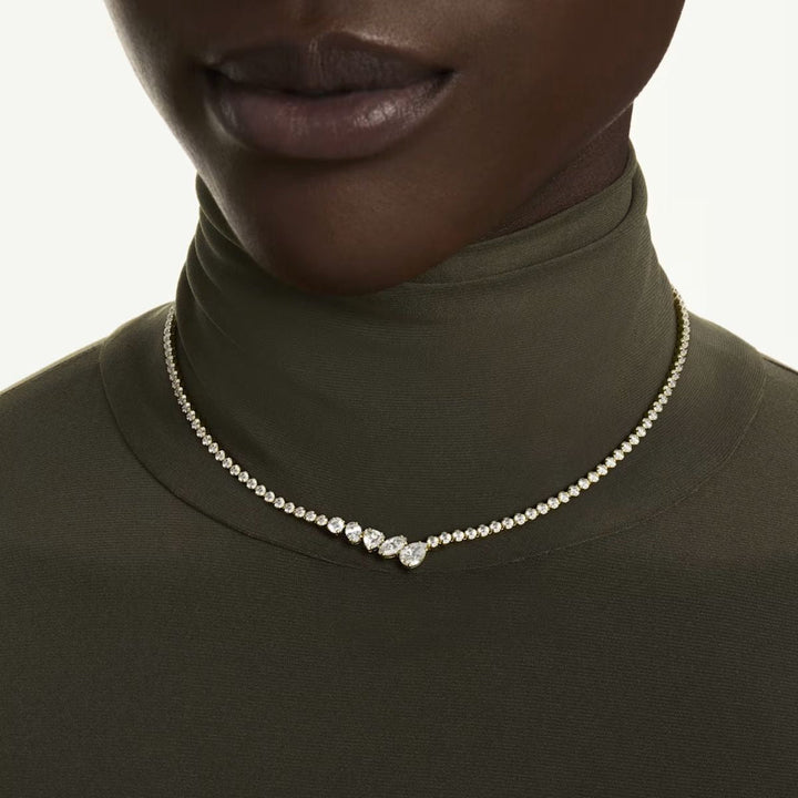 Niche Jewellery Swarovski Mesmera necklace featuring mixed cut white zirconia stones on an 18k gold finish cup chain.