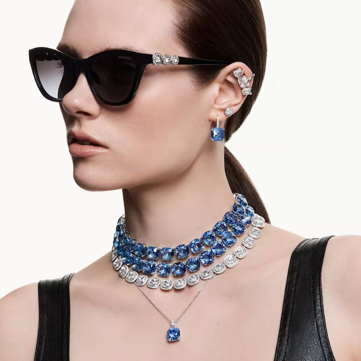 Niche Jewellery Swarovski Millenia cushion cut blue crystal pendant necklace worn by a model in black sunglasses