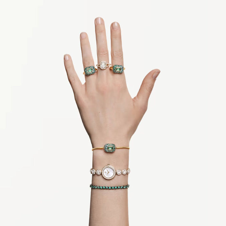 Niche Jewellery Swarovski Sublima green octagon cocktail ring with 18K gold finish worn on a hand with matching pieces