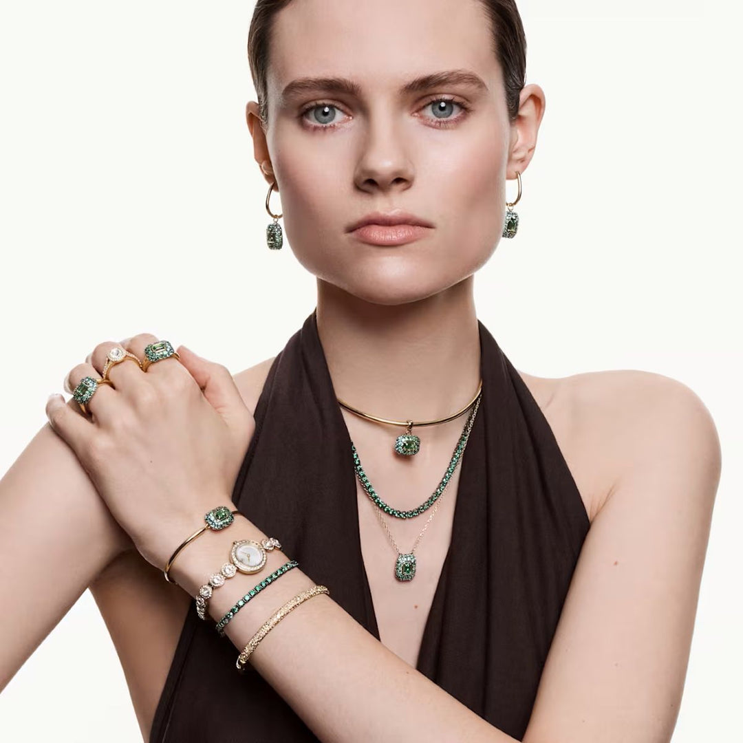 Niche Jewellery model wearing a Swarovski Sublima green octagon crystal cocktail ring with 18K gold finish