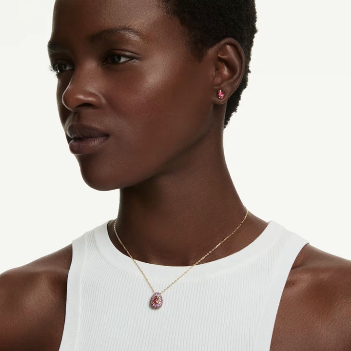 Niche Jewellery Swarovski Sublima set with red pear-cut crystals and 18K gold finish worn by a model