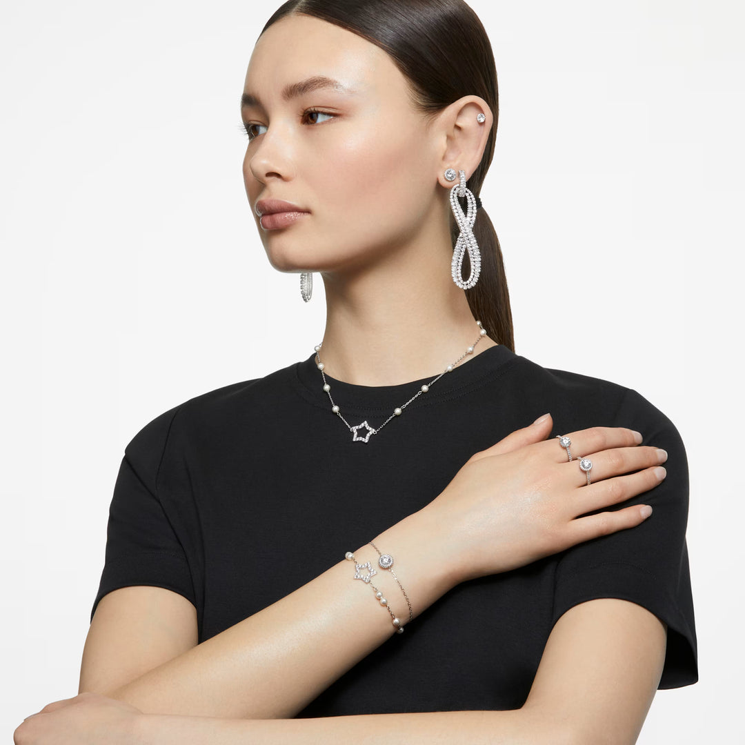 Niche Jewellery Swarovski Una Angelic ring with round-cut crystal and pavé halo on a silver-tone band worn by a model.