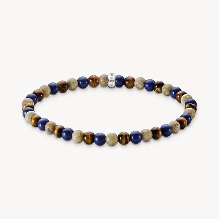 Thomas Sabo bracelet with brown tiger's eye, blue lapis lazuli, and beige daisy jasper beads. Features a silver accent bead.