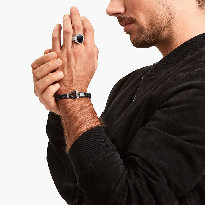 Niche Jewellery Thomas Sabo double braided black leather bracelet with a blackened silver toggle clasp on a man's wrist