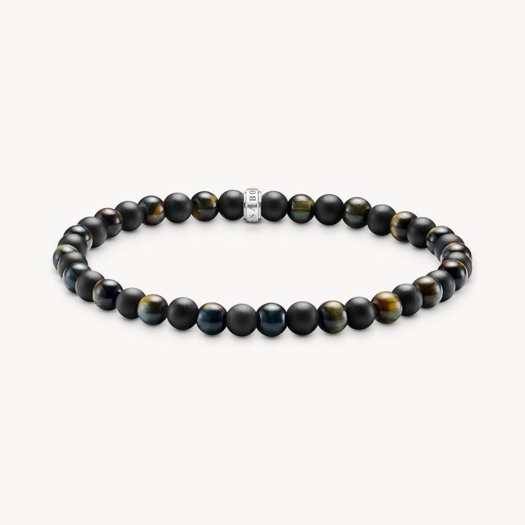 Thomas Sabo bracelet with matte black obsidian and blue-gold tiger's eye beads, featuring a central silver charm.
