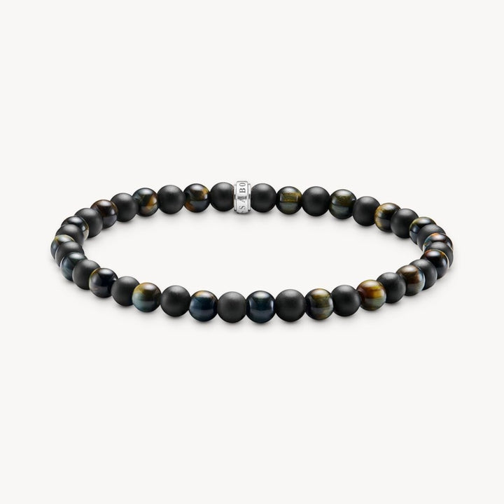 Thomas Sabo bracelet with matte black obsidian and blue-gold tiger's eye beads, featuring a central silver charm.