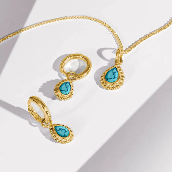 Niche Jewellery Charlotte's Web gold-plated necklace and hoop earrings set featuring pear-shaped turquoise December birthstones.