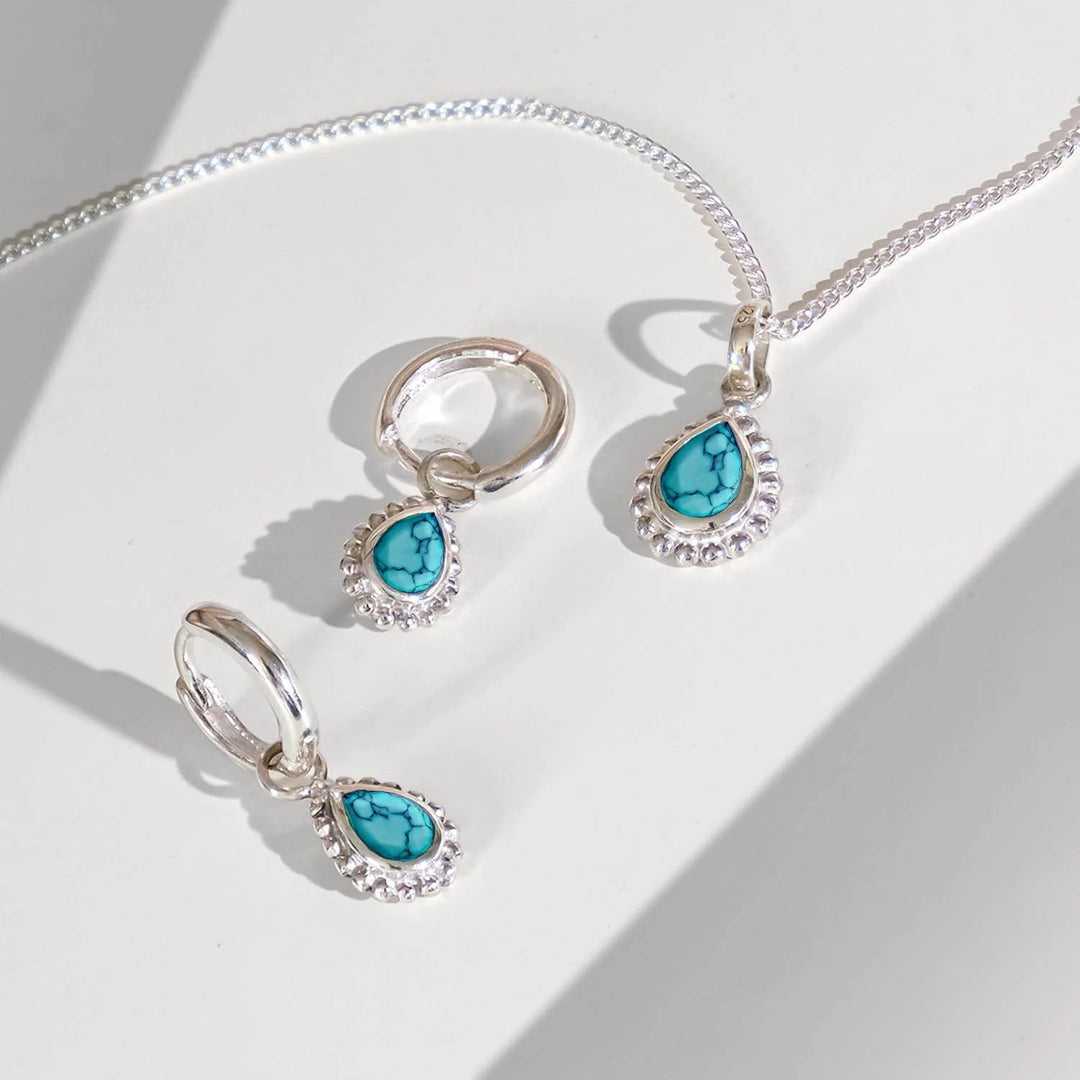 Niche Jewellery Charlotte's Web sterling silver huggie hoops and matching pendant featuring pear-cut turquoise December birthstones.