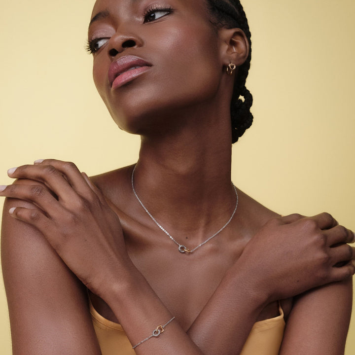 Niche Jewellery Olivia Burton two-tone silver and rose gold interlinking heart bracelet worn by a model