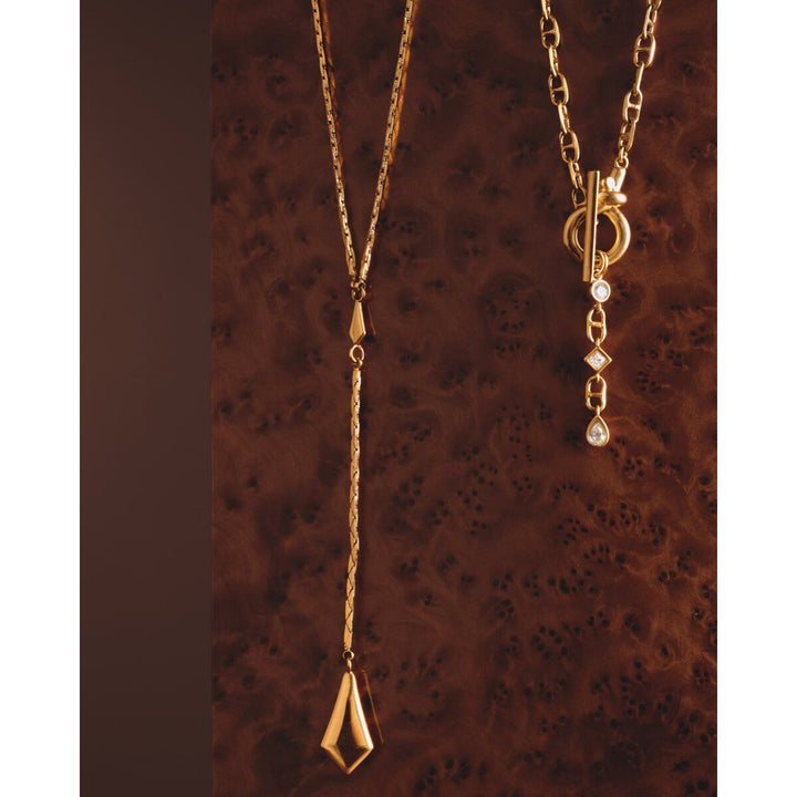 Niche Jewellery Katie Loxton waterproof gold necklaces with sparkling pendant and toggle clasp on dark wood background