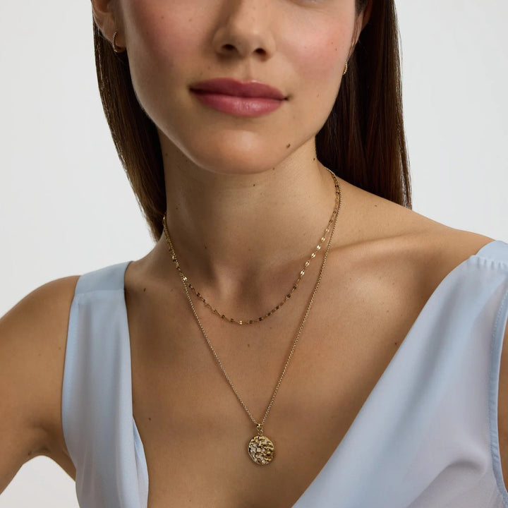 Niche Jewellery D.Louise gold zodiac talisman necklace for Aquarius with a textured coin pendant and a delicate chain.