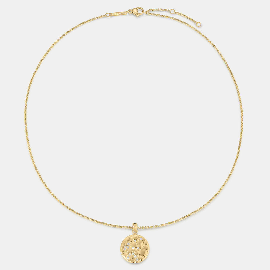 Niche Jewellery gold Aquarius zodiac talisman necklace with hammered finish and small diamonds.