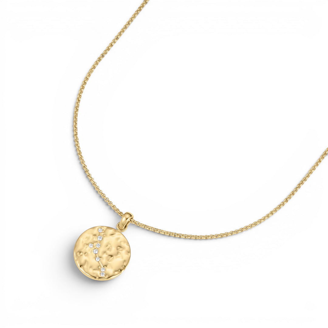 Niche Jewellery gold Taurus zodiac talisman necklace with hammered finish and diamond accents on a delicate chain.