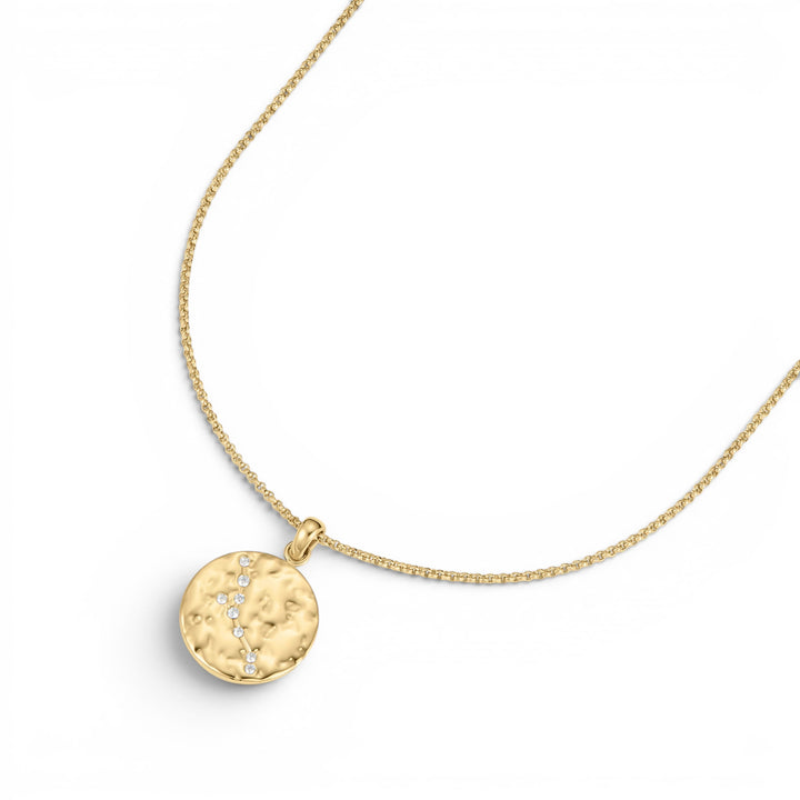 Niche Jewellery gold Taurus zodiac talisman necklace with hammered finish and diamond accents on a delicate chain.