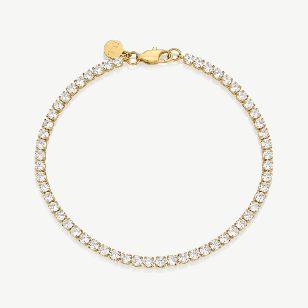 Niche Jewellery D.Louise gold tennis bracelet with large cubic zirconia stones in a bezel setting.