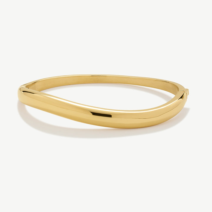Niche Jewellery gold-tone wave bangle with a polished finish, perfect for everyday wear.