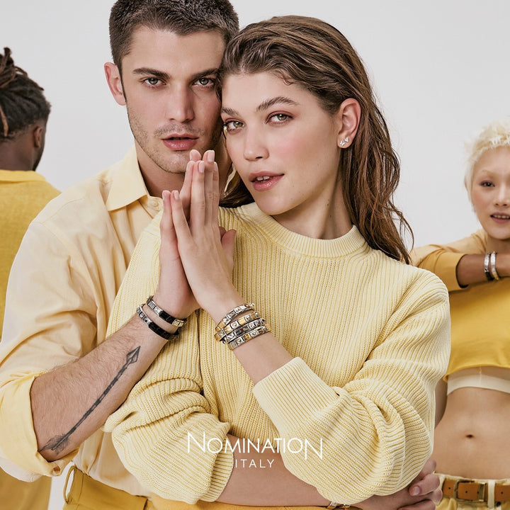 Niche Jewellery Nomination Classic Gold Love You Charm bracelet with heart detail. Model wears yellow sweater.