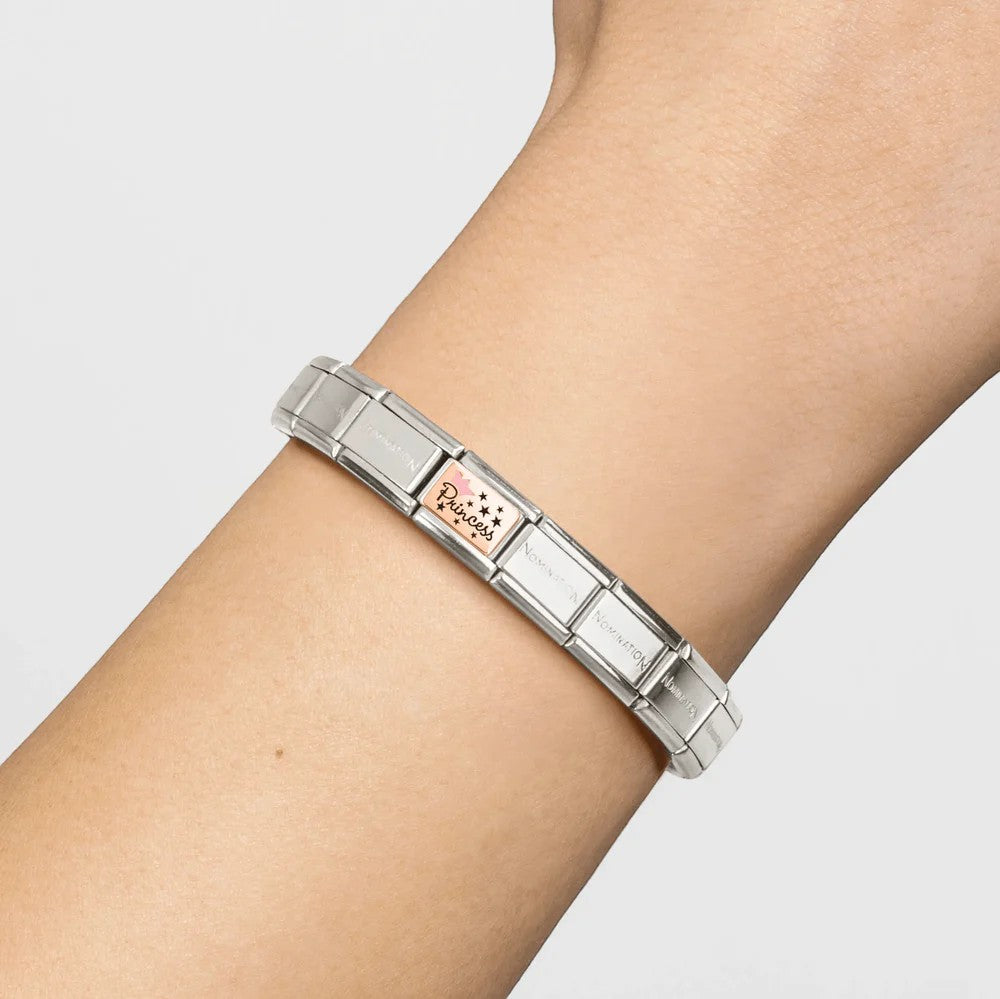 Niche Jewellery Nomination rose gold charm with pink enamel crown and 'Princess' text on a bracelet.