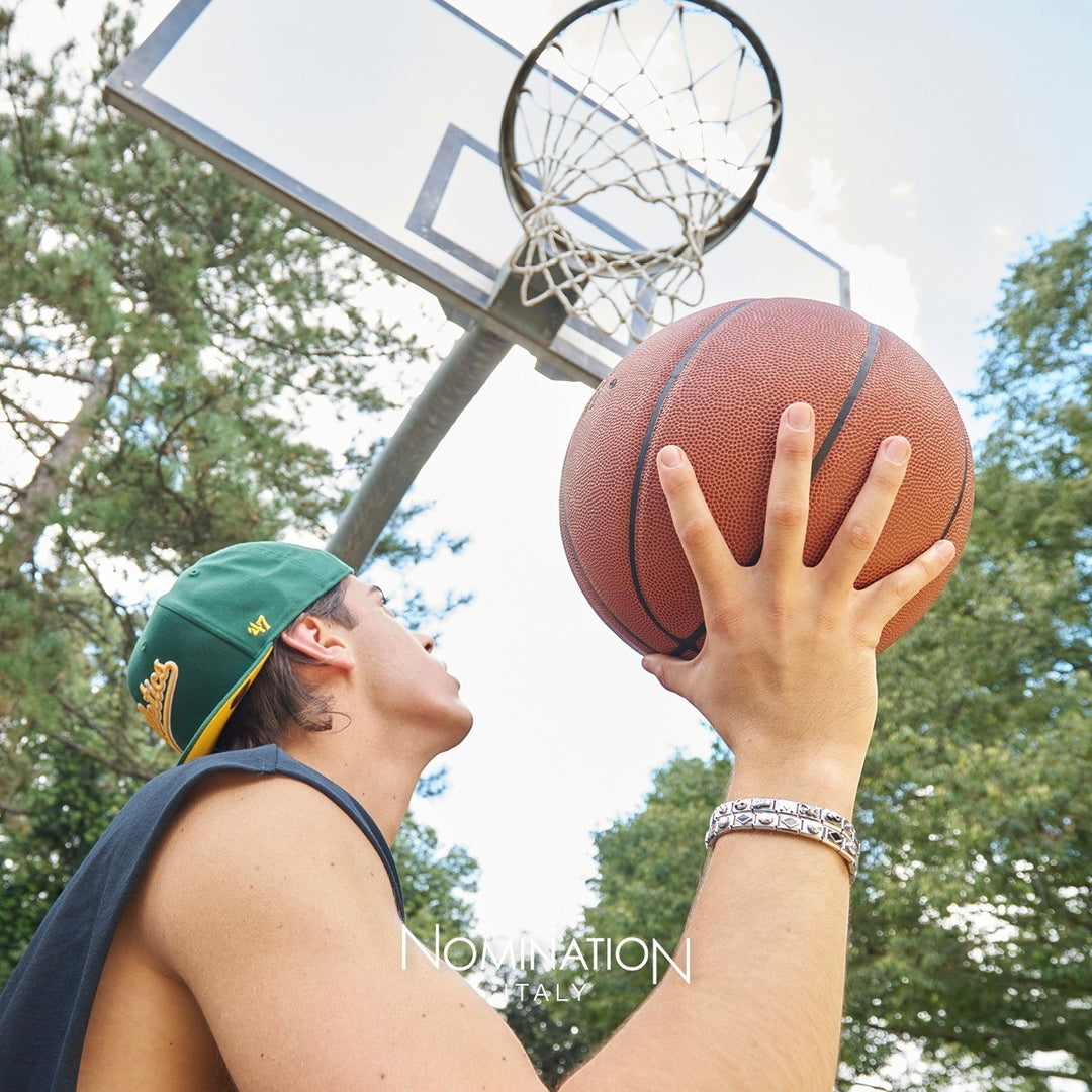 Niche Jewellery Nomination Classic Oxidised Skull Silver Charm on a man's wrist, styled with a basketball and cap.