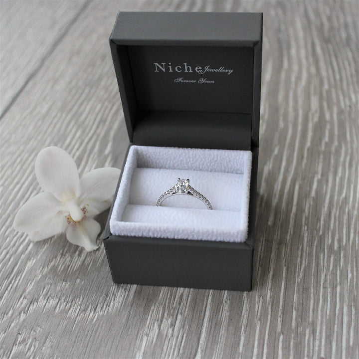 Oval cut diamond engagement ring with diamond shoulders