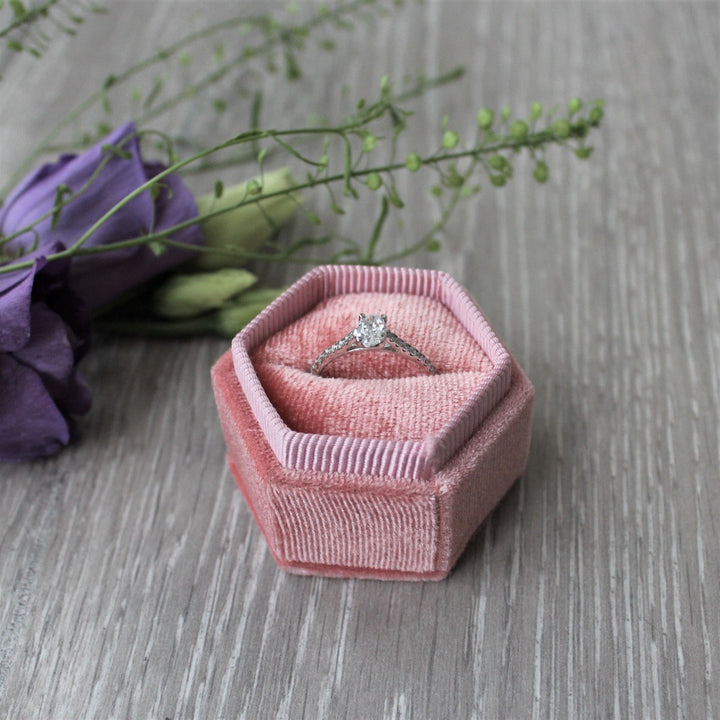 Oval cut diamond engagement ring with diamond shoulders