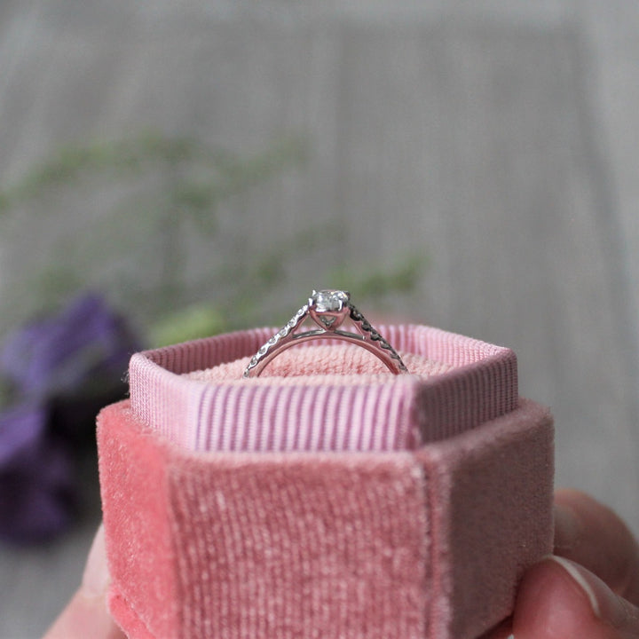 Oval cut diamond engagement ring with diamond shoulders