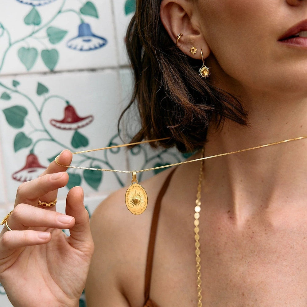 Rachel Jackson gold huggie hoop earrings with hand-carved citrine sun motifs and Art Deco rays. Secure click fastening.