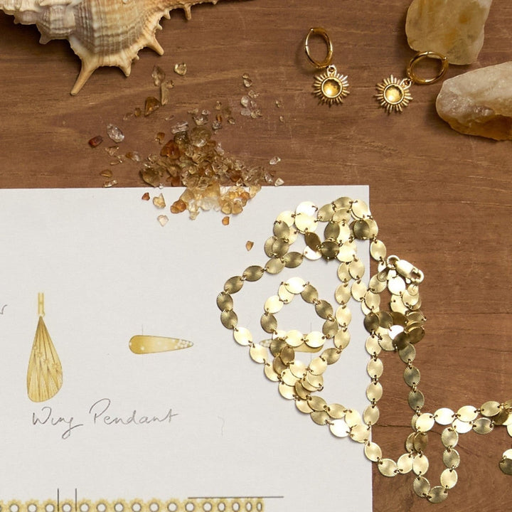 Rachel Jackson gold huggie hoop earrings with sun motif and citrine stones, part of the Dreamer collection.