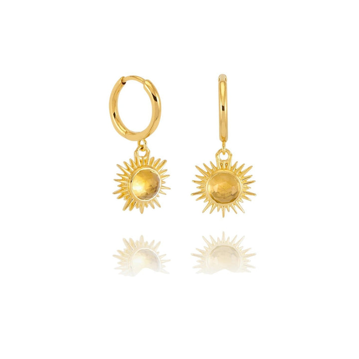 Rachel Jackson gold huggie hoop earrings with hand-carved citrine sun charms and Art Deco rays. Secure click fastening.