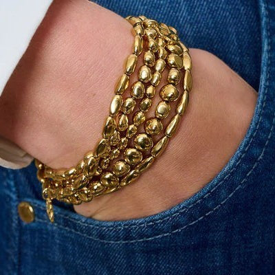 Niche Jewellery Boho Betty Saffron gold stretch bracelet with smooth, pebble-shaped beads. Waterproof 14k PVD gold plating.