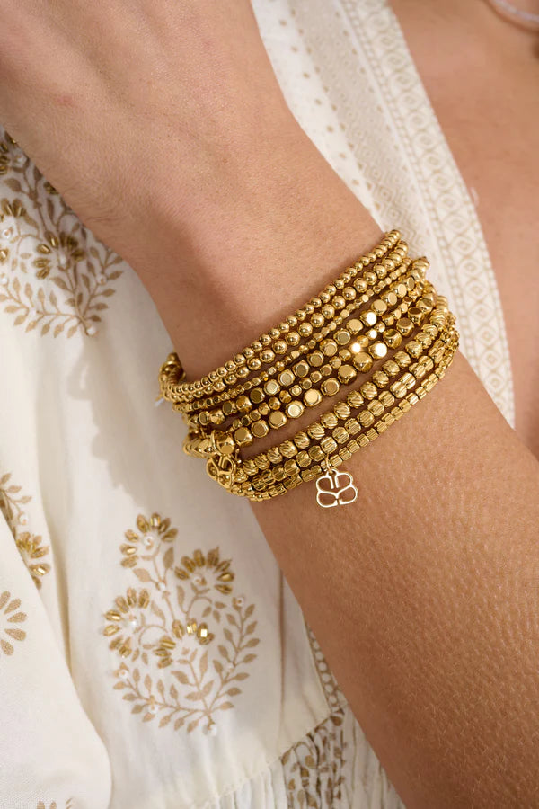 Gold stacking bracelets by Boho Betty on wrist.