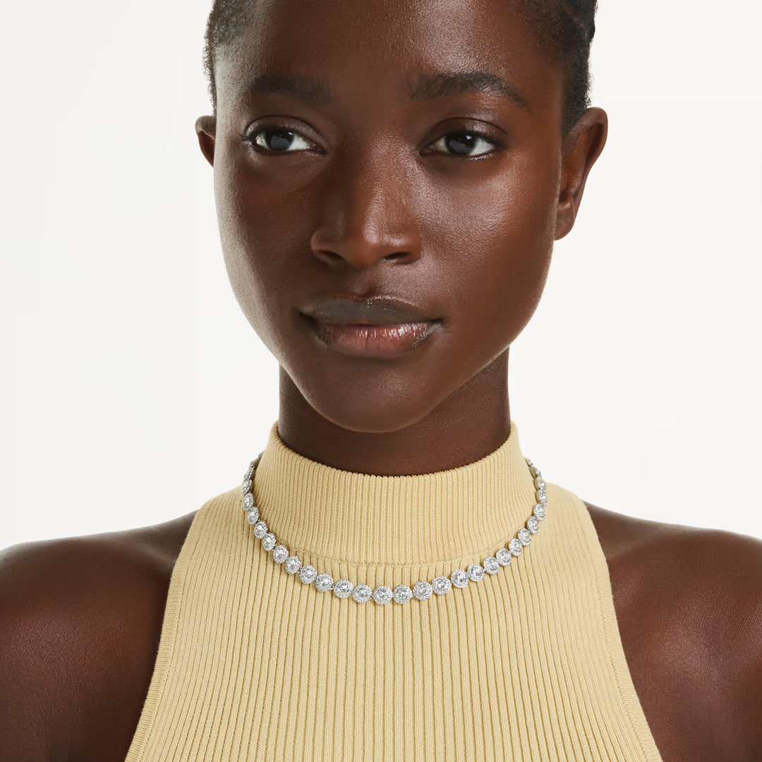 Swarovski Una Angelic All Around Necklace - White with Rhodium Plating on model wearing a yellow top and silver necklace on a white background